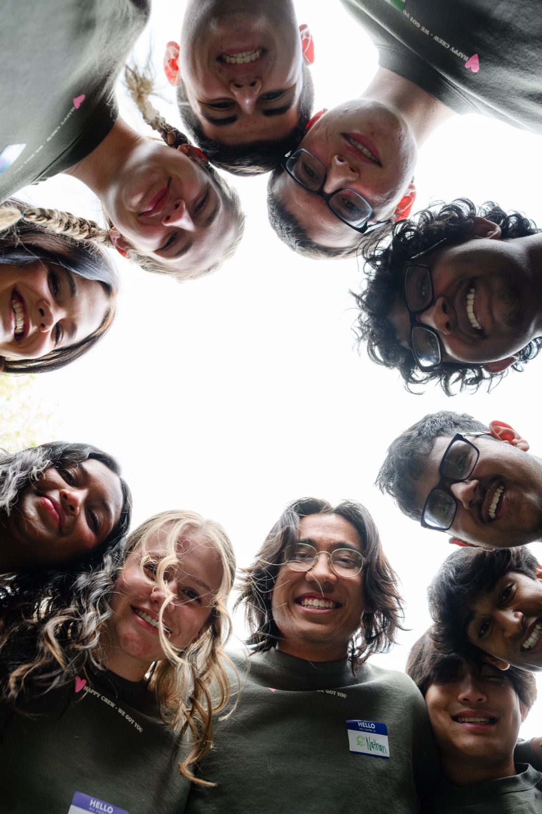 A circle of teens looking down at the camera